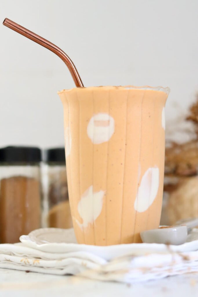 Close up of a thick pumpkin protein smoothie in a glass