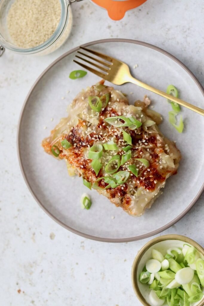 Close-up of rice paper lasagna garnished with spring onion and sesame seeds