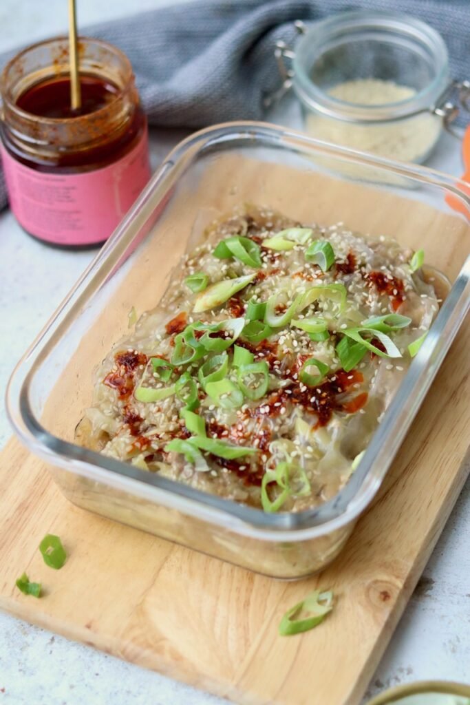 Steamed rice paper lasagna in a glass dish drizzled with chilli crisp