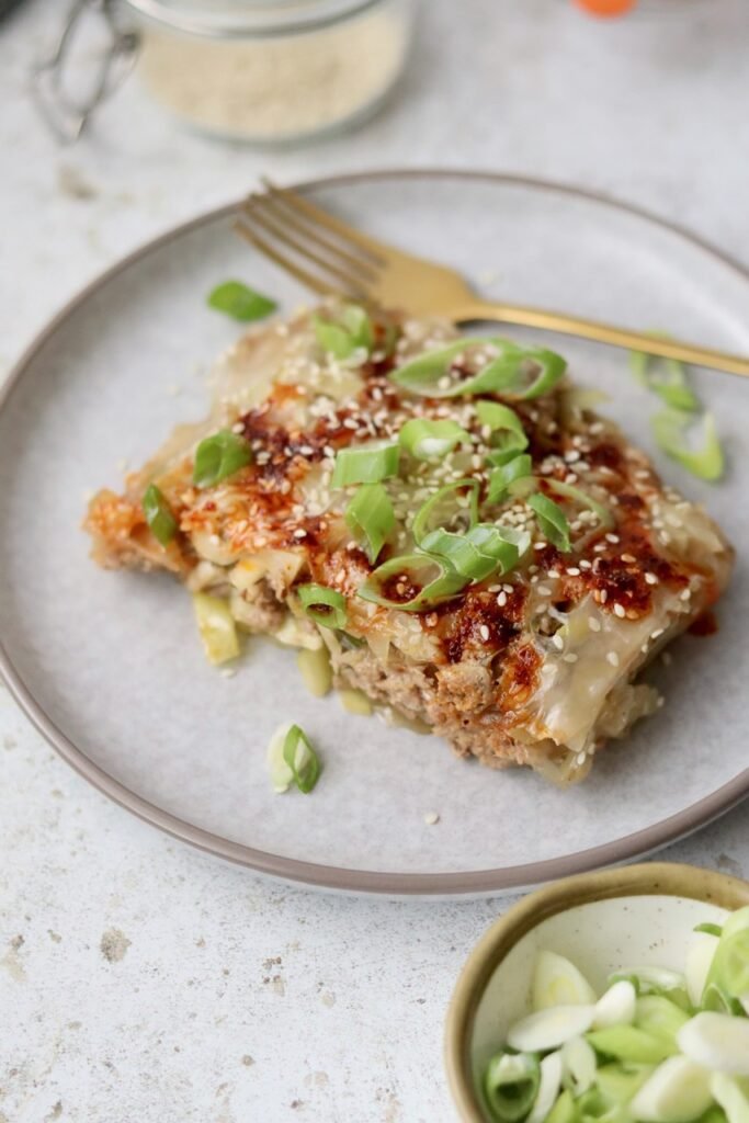 Slice of rice paper lasagna on a plate showing the layered beef and pork filling