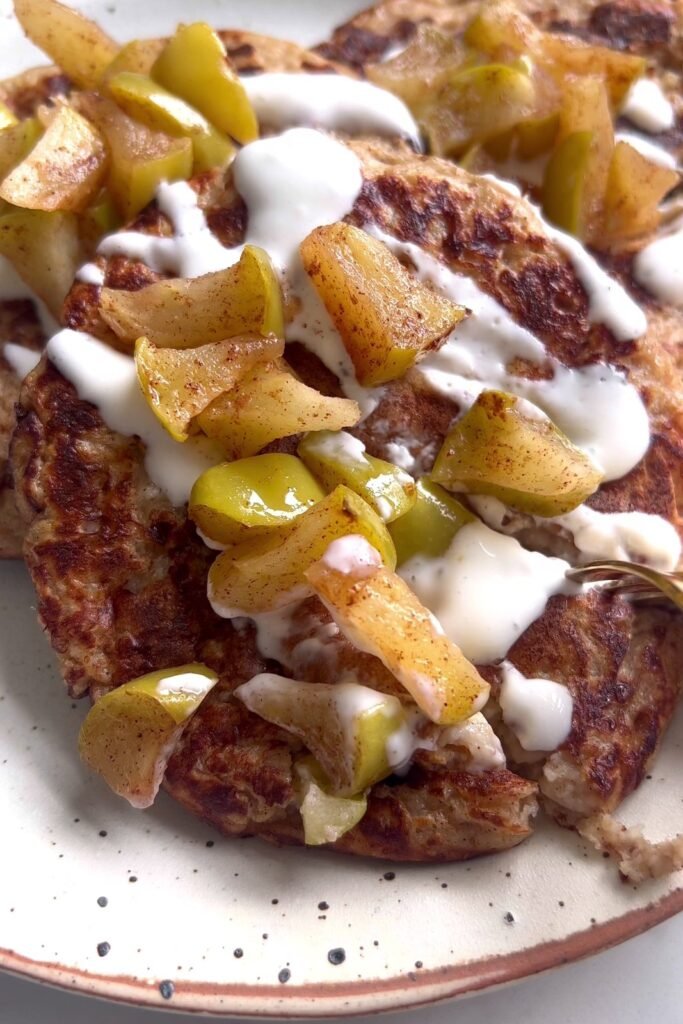 Cutting into a stack of apple pie cottage cheese pancakes