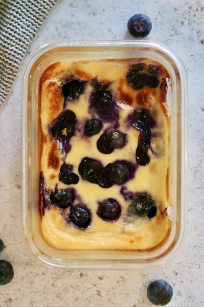 Overhead view of blueberry baked Greek yogurt in a glass dish