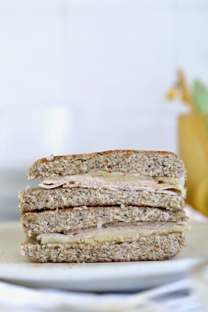 A stack of chia seed bread sandwiches with turkey and cheese