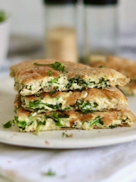 Stacked wedges of rice paper spanakopita with spinach and feta filling