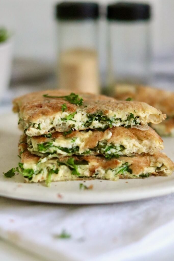 Stacked wedges of rice paper spanakopita with spinach and feta filling