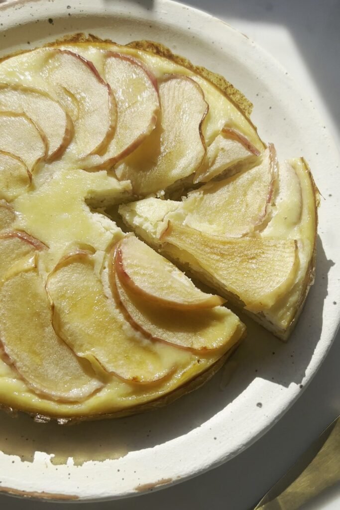 Healthy apple cake on a plate with one slice cut out