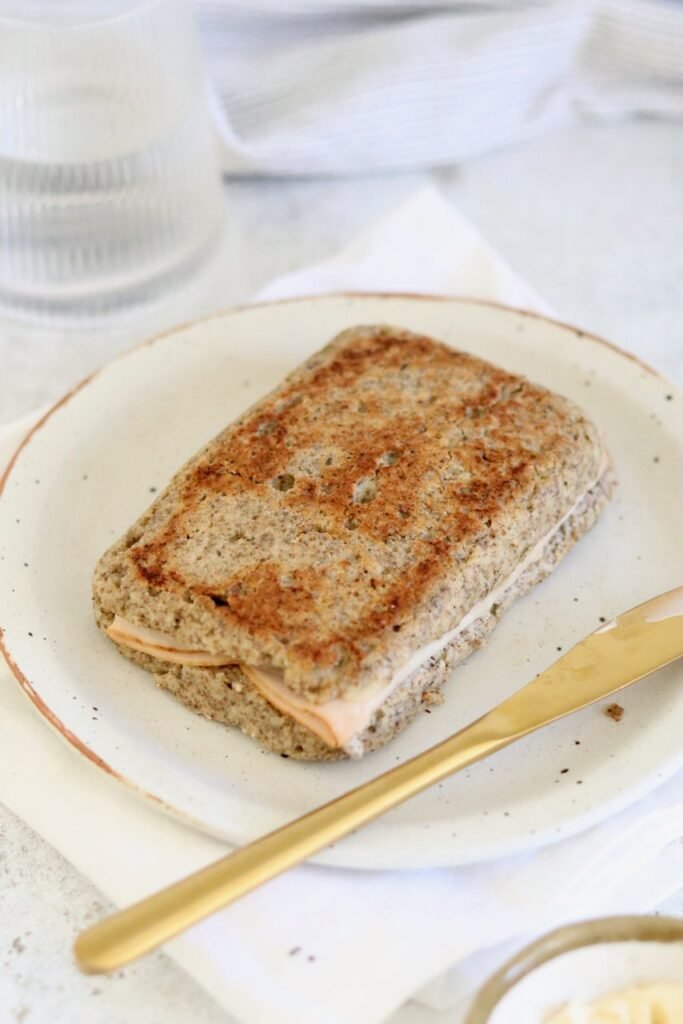 A toasted microwave keto bread toastie with cheese and turkey on a plate