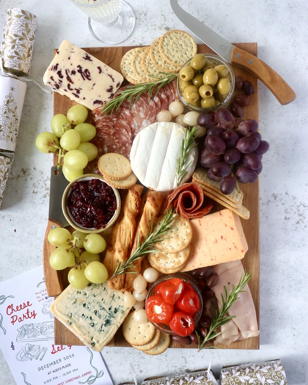 Christmas cheese and charcuterie board with wooden-handled cheese knives