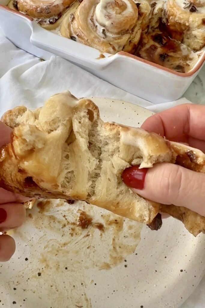 Mince pie cinnamon roll pulled apart to show the soft fruity layers