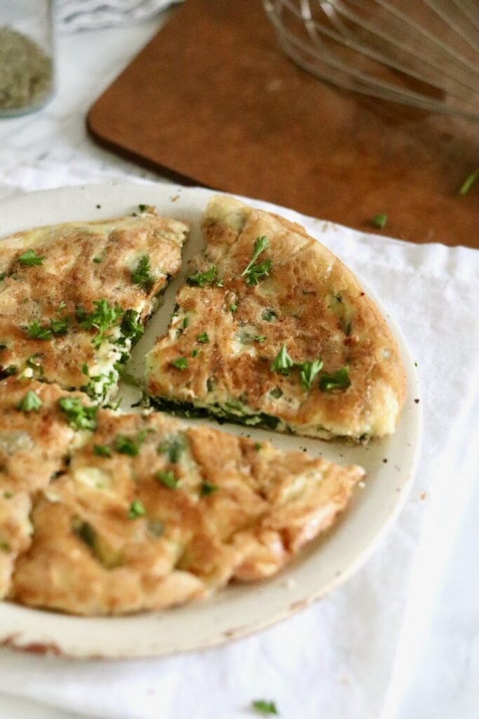 Whole gluten free spanakopita made with rice paper, cut into wedges