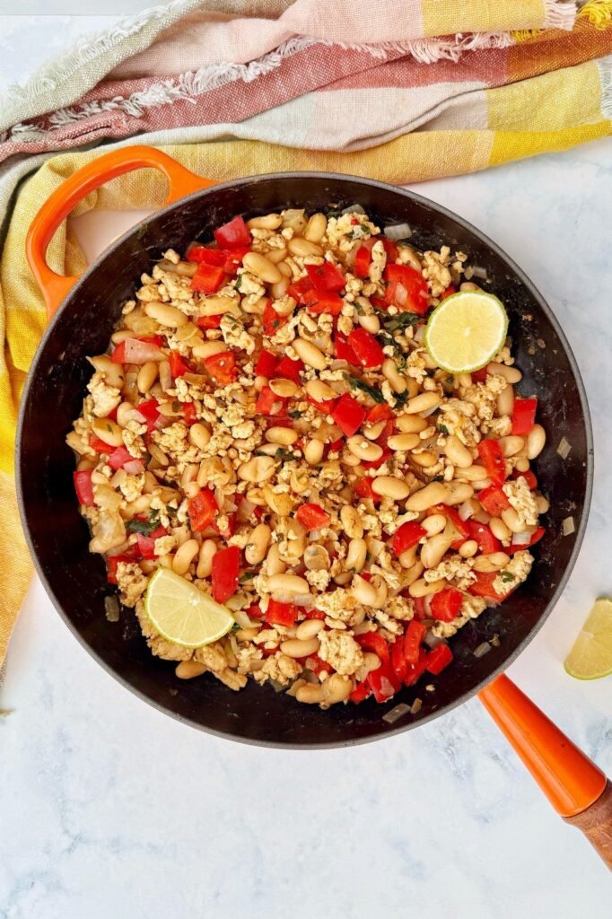 Turkey and white bean chili with red pepper and lime in a cast iron pan