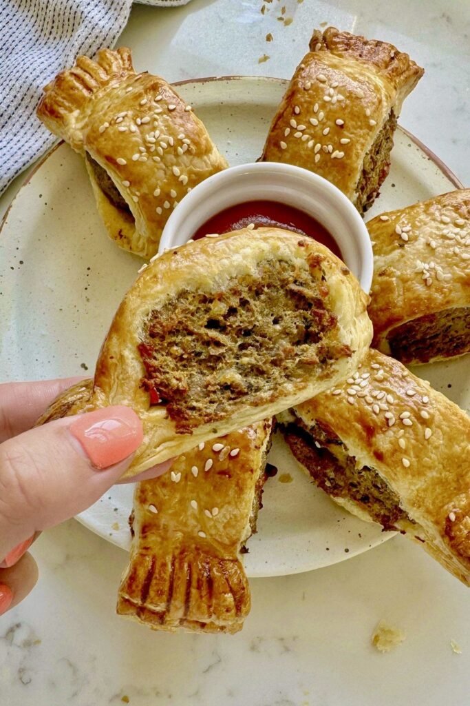 Vegetarian sausage roll cut open to show the chimichurri and cheese filling